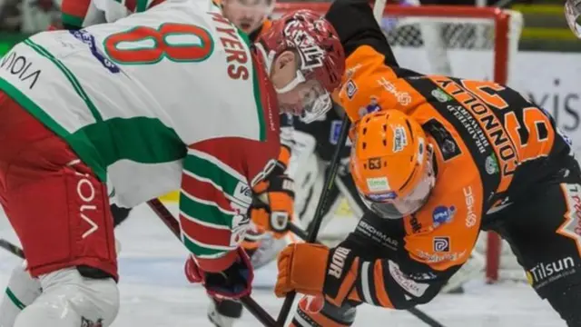 Sheffield Steelers player challenges for the puck