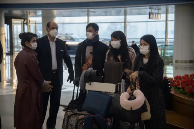 Foreign embassy staff arriving for the first commercial flight out of Pyongyang for over a month.