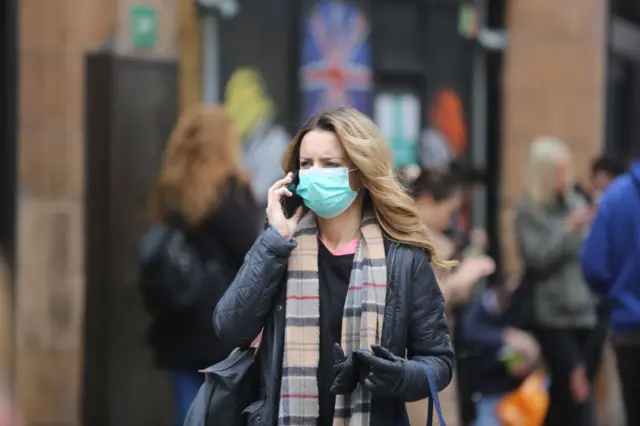 People wear medical masks as a precaution against coronavirus in central London,