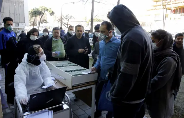 An Iranian lab official registers people for Covid-19 coronavirus test outside a lab in Tehran, Iran, 09 March 2020.