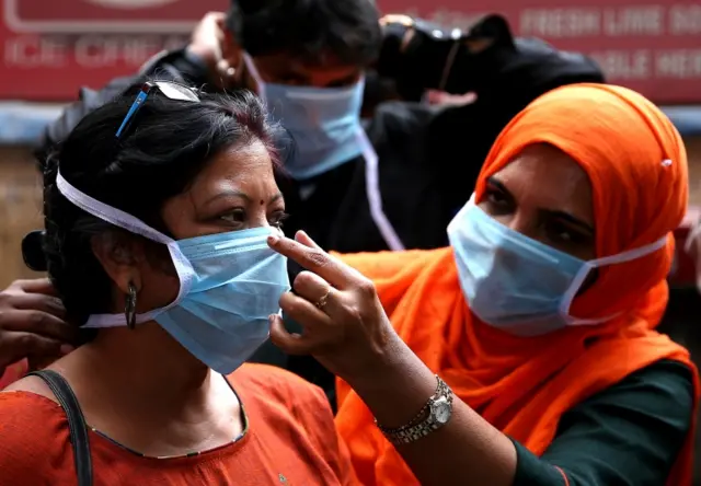 embers of Victoria Hospital Medical staff demonstrate to the public on how to use protective mask, during awareness campaign following the coronavirus outbreak, in Bangalore, India, 05 March 2020.