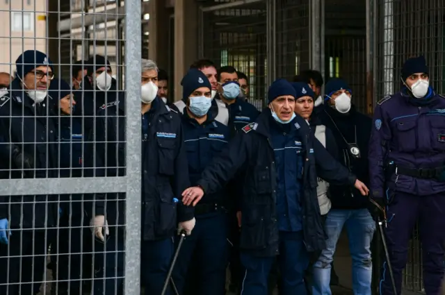 Police stand guard at entrance to Modena prison