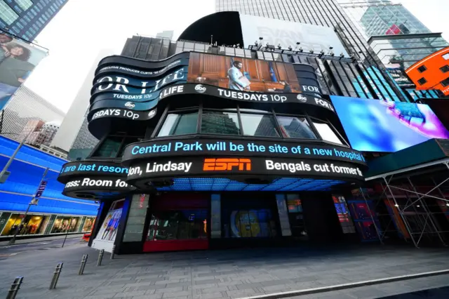 News reports flash in an eerily empty Times Square