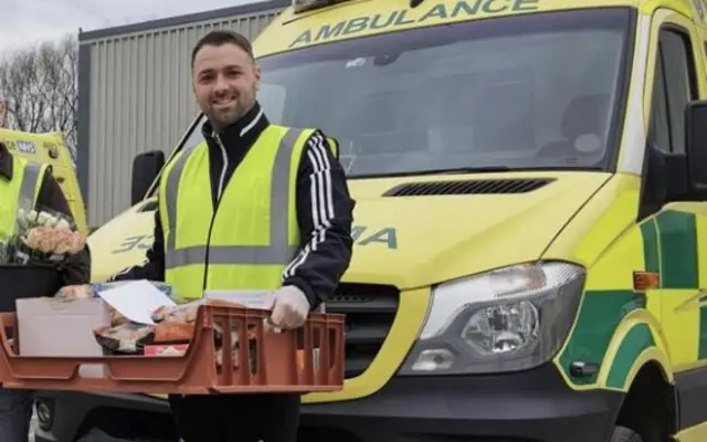 Paramedic with food and flowers