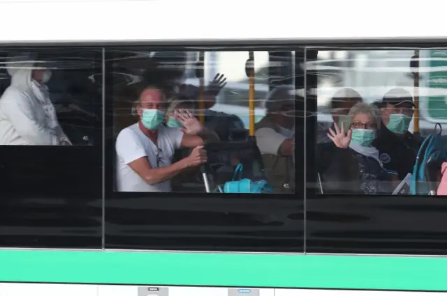 Some of the German passengers taken off the Artania last week on a bus to the airport in Fremantle