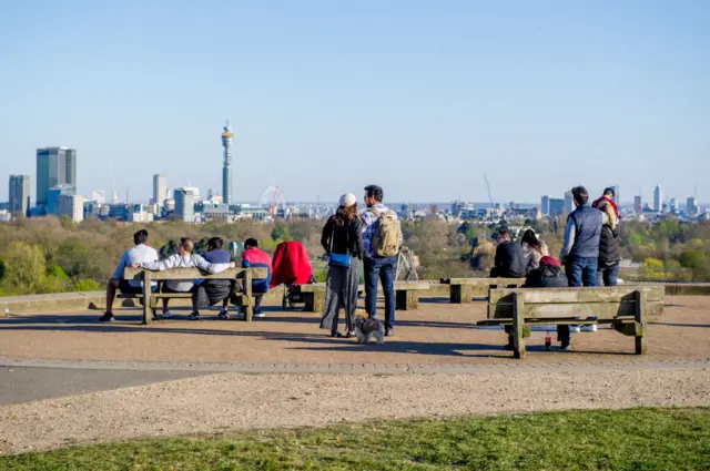 Members of the public enjoy the day's warm weather on Primrose Hill on April 5, 2020 in London, England.