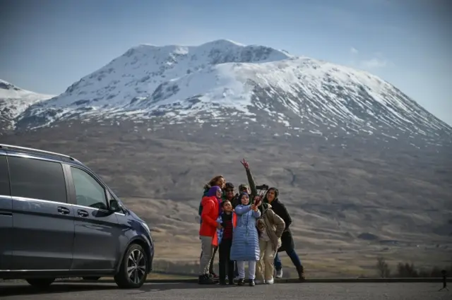 Tourists take a selfie in Glen Coe