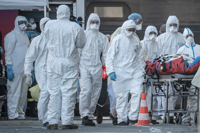 French medics wearing hazmat suits