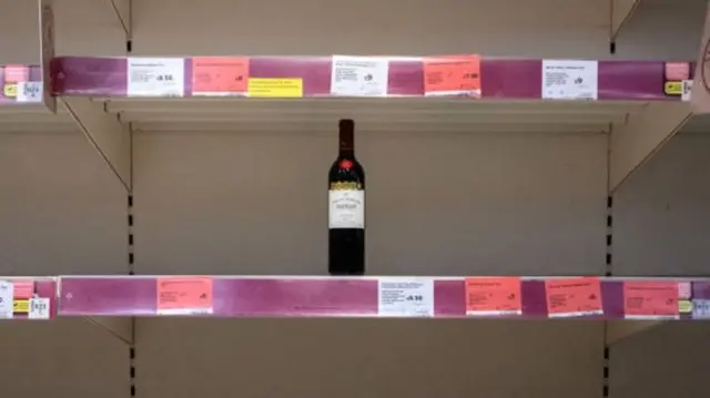 single bottle of wine on shelf