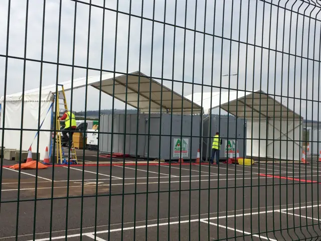 Workers set up a coronavirus testing facility at Aberdeen airport