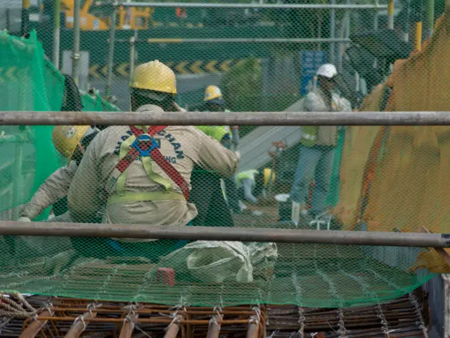 Migrant workers at a construction site by a highway in Singapore.