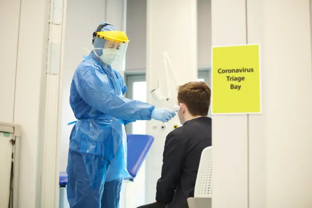 Doctor in mask, gown and gloves