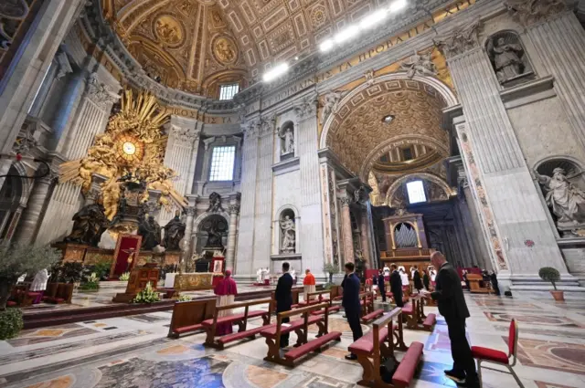 A general view shows few attendees and Pope Francis (Rear C) as he celebrates Easter Sunday Mass