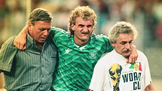 Rudi Voller is helped from the pitch