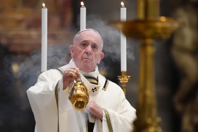 Pope Francis swings a thurible at the start of Easter Sunday Mass behind closed doors at St. Peter's Basilica