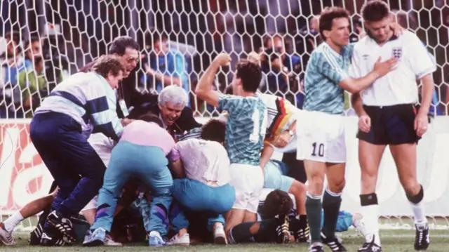 Lothar Matthaus consoles Chris Waddle as West Germany celebrate