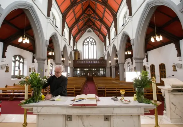 Father Tom Devlin prepares to celebrate Easter Sunday mass at at St Bridget"s RC Church in the parish of St Ambrose in Baillieston, Glasgow