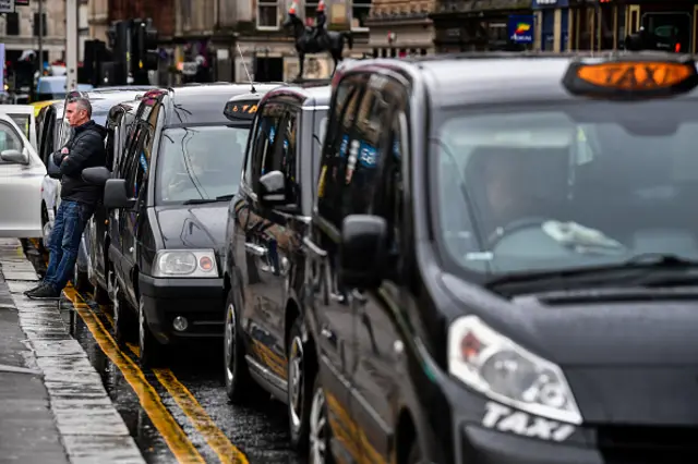 Taxis queue up in Glasgow's George Square as people are asked to work from home and socially distance themselves due to the Coronavirus pandemic earlier in March