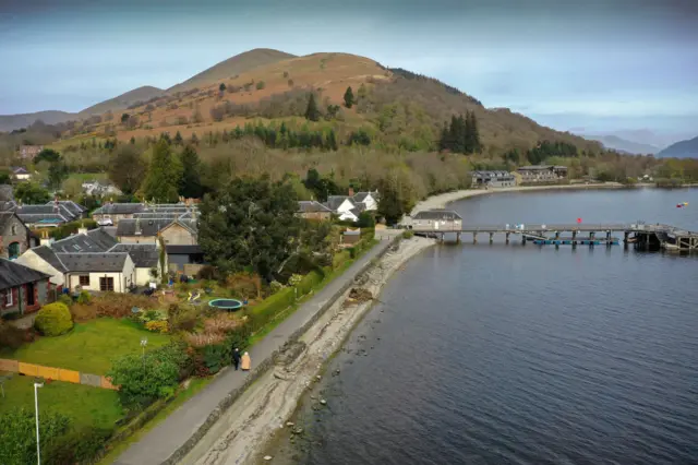 A couple walk along the shore at Luss during the Coronavirus lockdown on April 12, 2020 in Luss, Scotland