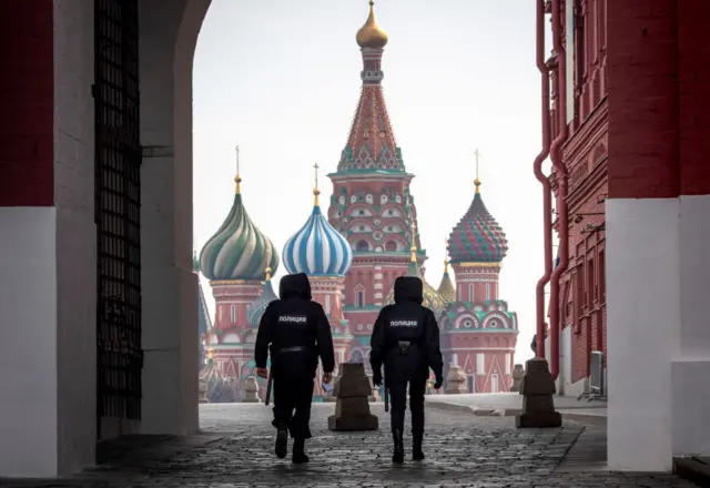 Police patrol a deserted Red Square in Moscow