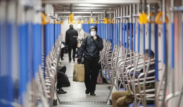 A man wearing a face mask walks in the Moscow Metro