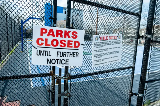 A 'Parks Closed' sign on a padlocked gate