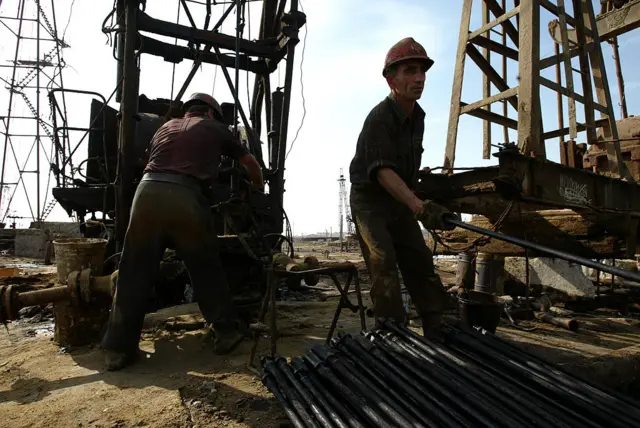 Oil workers outside of Azerbaijan's capital city of Baku