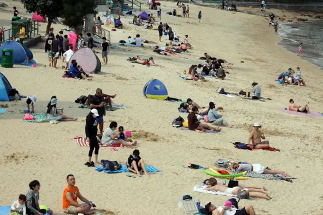 Beachgoers on Hong Kong's Stanley Beach on 10 April 2020