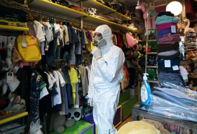 A health inspector examines a Rome children's goods store, 14 Apr 20