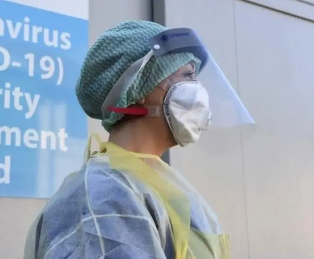 An NHS worker wearing a visor