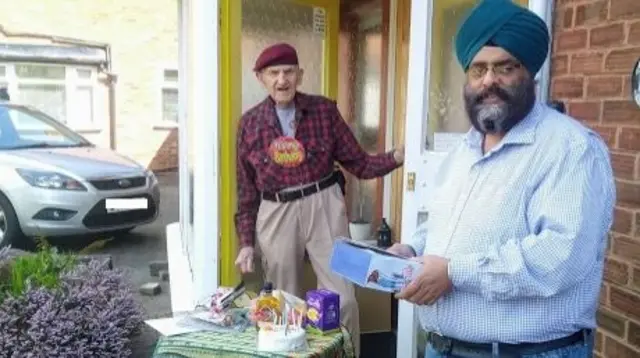 Eddie Moore with neighbour outside house