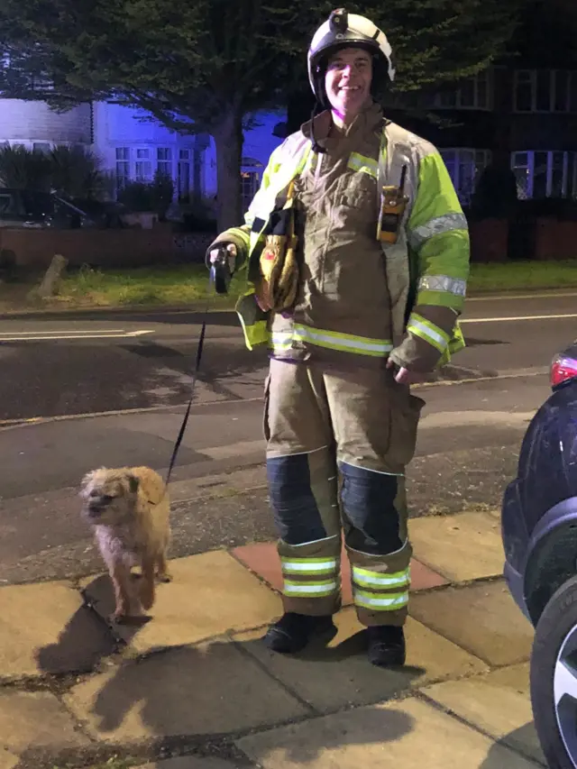 Firefighter with rescued dog