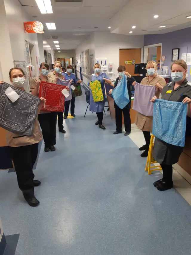 Hospital staff with uniform wash bags made by volunteers