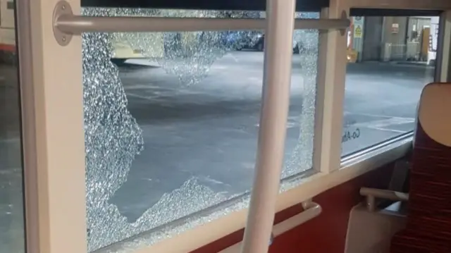 A smashed bus window