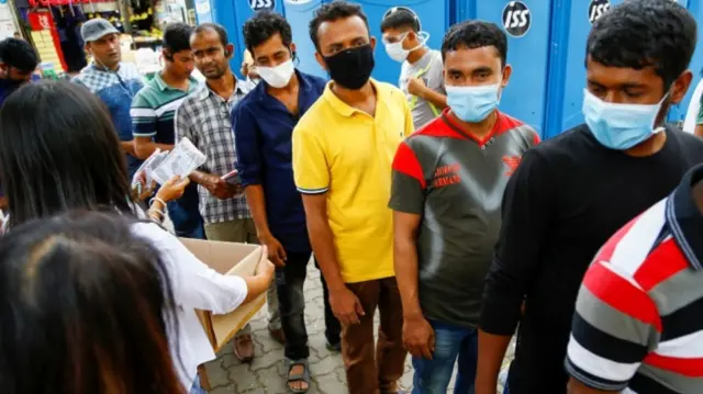 Workers wearing face masks