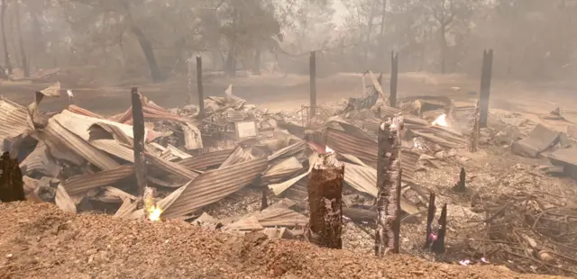 The completely burnt remains of Lorena Granados' shop after the fires