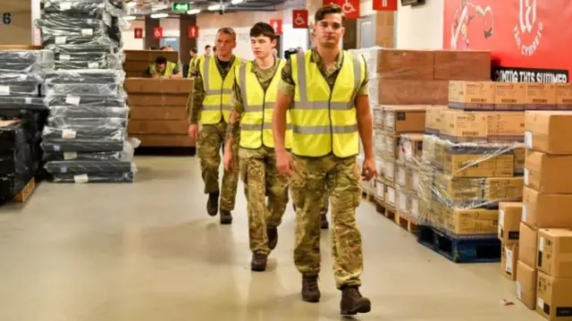 Army personnel help move medical supplies at the Principality Stadium, Cardiff, as it is turned into a field hospital