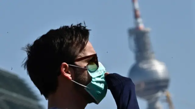 Masked man in front of Berlin TV tower