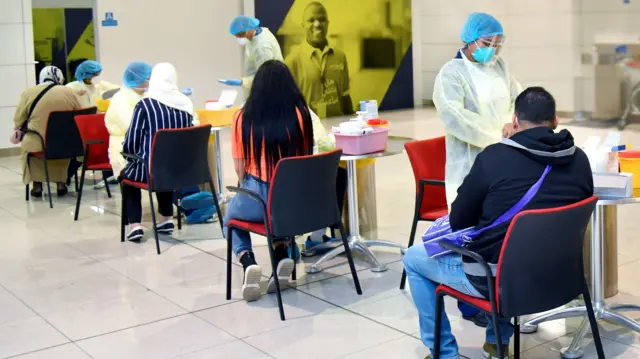 Passengers are tested for Covid-19 at the Group Check-in area of Dubai International Airport Terminal 3