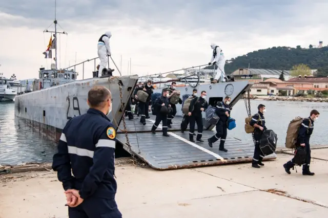 A French Navy handout of sailors coming ashore from the carrier