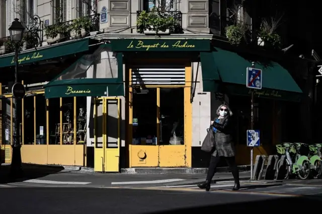 A pedestrian wears a face mask in Paris