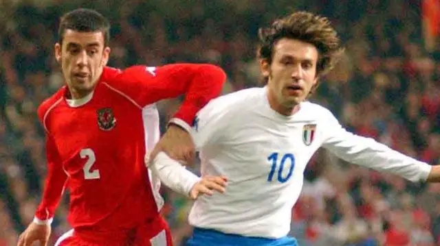 Italy's Andrea Pirlo (right) challenged Mark Delaney of Wales