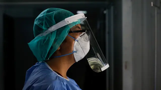 Medical worker wears personal protective equipment