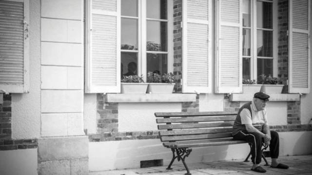 Elderly man sitting on a bench