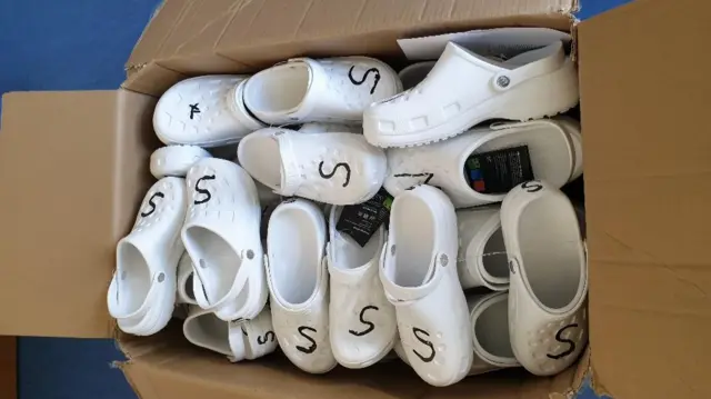 Box of white clogs