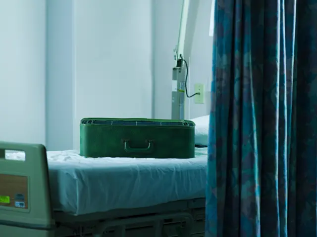 Suitcase on hospital bed