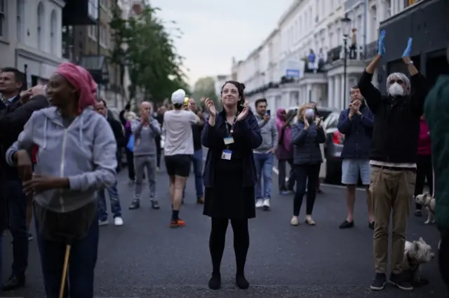 People clap outside Chelsea and Westminster hospital in London