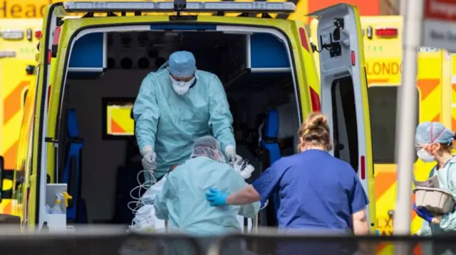 A patient is taken into an ambulance