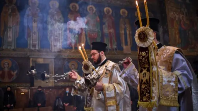 Bulgarian East-Orthodox priest kisses an icon during the Good Friday service in St. Nedelya Church in Sofia