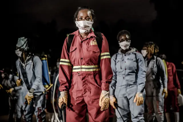 Members of an NGO working with county officials wearing protective kit in Kenya